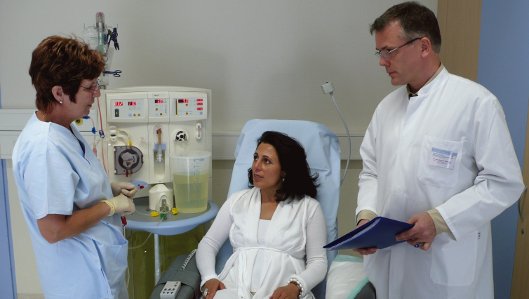 Dialyse-Patientin im Gespräch mit zwei Ärzten